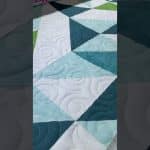 Joyce’s 1/2 HST quilt - Longarm quilted by Maynard Longarm Quilting