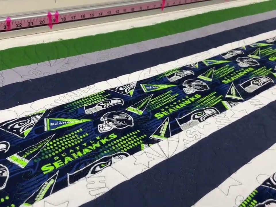 Lori’s “Seahawks” quilt - Longarm quilted by Maynard Longarm Quilting