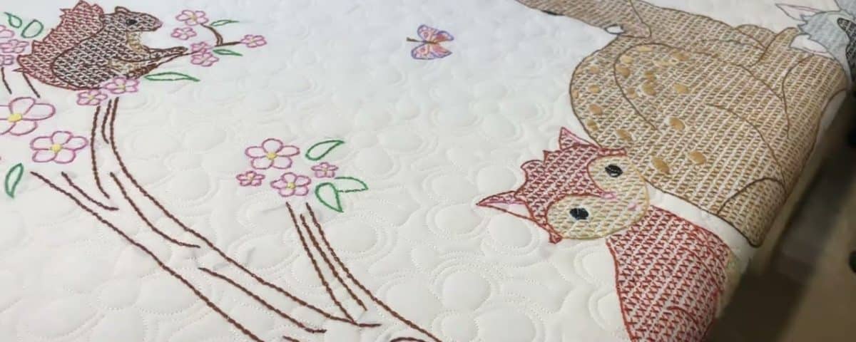 Delores’s “Crossed-stitch Animal” quilt - Longarm quilted by Maynard Longarm Quilting