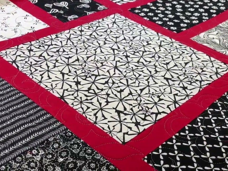 Barb’s “B&W w/ red shashing” quilt - Longarm quilted by Maynard Longarm Quilting