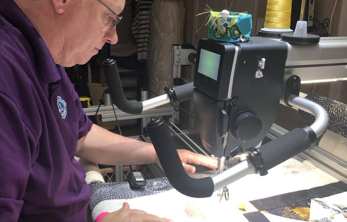 Leo working at the Bernina Q24 longarm machine in the Maynard studio