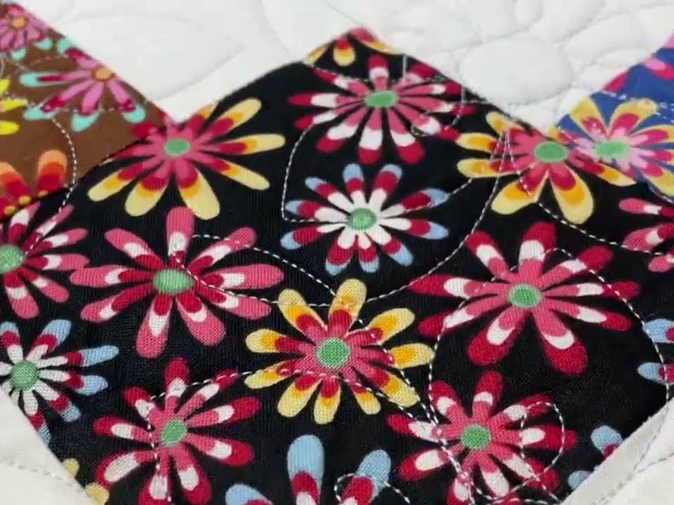 Lori’s “Flower Power” quilt - Longarm quilted by Maynard Longarm Quilting