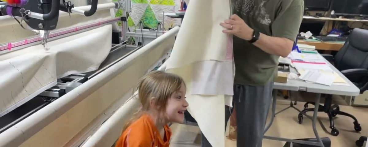 Charlotte taking her finished quilt off the frame! - Longarm quilted by Maynard Longarm Quilting