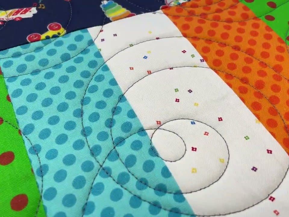 Leslie’s “Fisher Price” kid’s quilt - Longarm quilted by Maynard Longarm Quilting